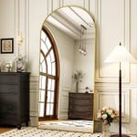 A classic hallway featuring an arched window, a large ornate mirror, chest drawers, a standing lamp, and pendant lights.