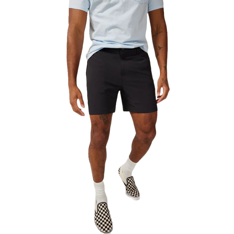Man wearing a light blue shirt, black shorts, white socks, and checkered slip-on shoes.