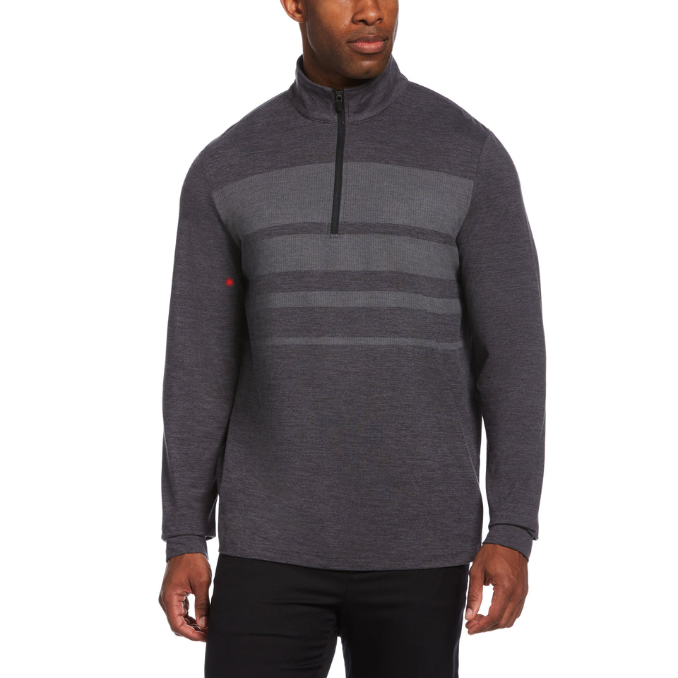 A man wearing a dark gray half-zip pullover with horizontal stripe details.