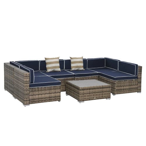 7-piece modular patio sectional set with wicker frame and navy cushions featuring white piping. Includes a corner sofa, two armless chairs, an ottoman, and a square coffee table. Comes with two striped accent pillows.