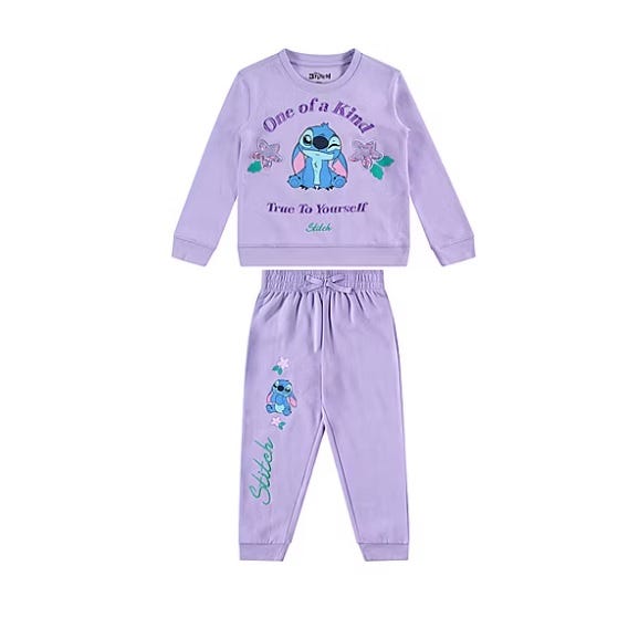 A lavender-colored children's tracksuit featuring a \“Stitch\“ character design. The set includes a long-sleeve top with \“One of a Kind, True To Yourself\“ text and matching pants with elastic waistbands and cuffs.