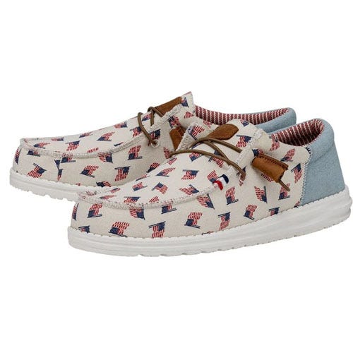 A pair of casual loafers with an American flag print and leather laces.
