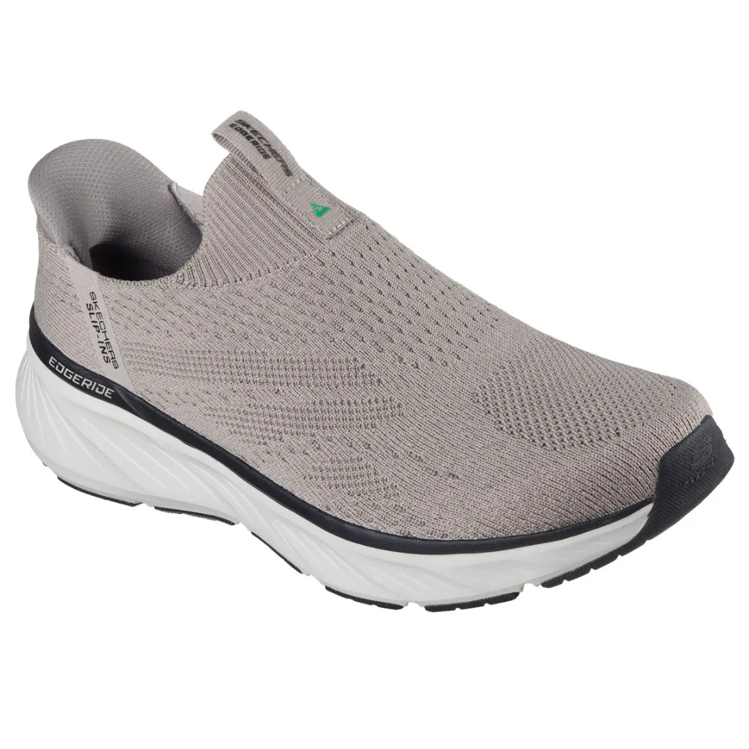 A beige slip-on sneaker with a knitted upper, labeled as Skechers, featuring \“Edgeride\“ on the side and a contrasting black toe cap and sole.