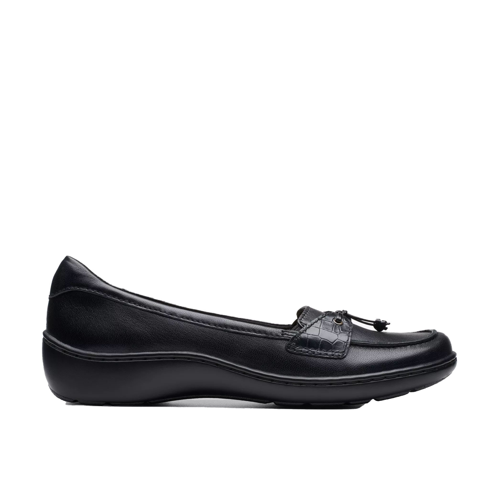 The Clarks Cora Haley Loafers are sleek black leather shoes featuring a stitched moccasin-style front with a tassel detail, a low-rise, cushioned heel, and subtle textured side panels for a comfortable, casual look.