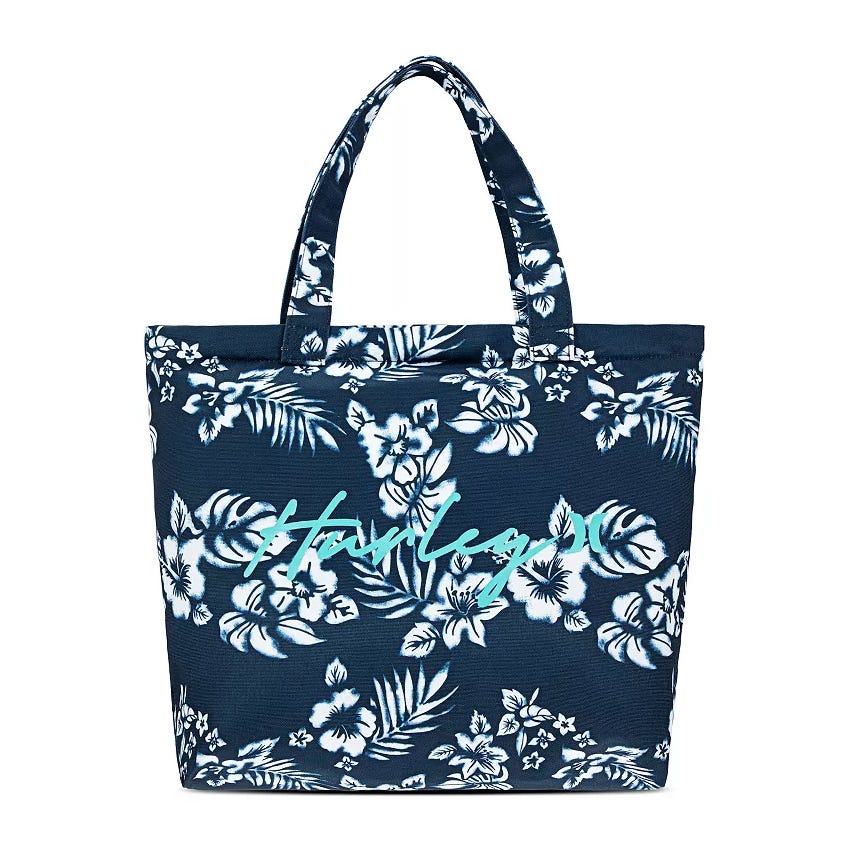 Blue tote bag with white floral pattern and \“Hurley\“ written in light blue script.