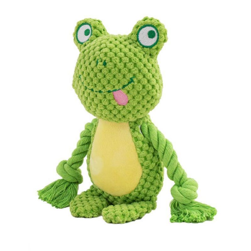 A green, frog-shaped chew toy made of soft yarn with a yellow belly and large eyes, featuring tassels for arms and legs.