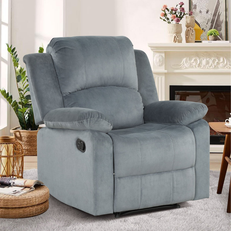 A gray recliner chair with a plush cushioned backrest and armrests, situated in a living room setting.