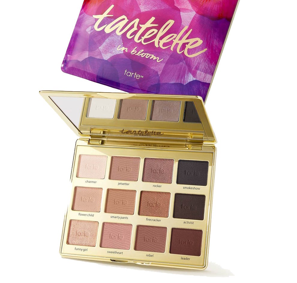 Tartelette In Bloom eyeshadow palette by Tarte, featuring 12 shades in matte and shimmer finishes, encased in a purple and pink floral compact with a mirror.