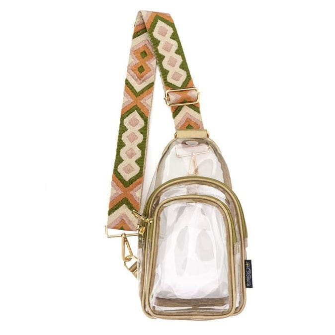 Clear crossbody bag with a geometric patterned strap in green, orange, and beige. The bag has gold zippers and a transparent body.