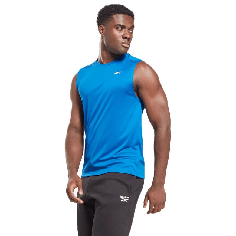 A blue Reebok Training Tank featuring a sleeveless design with a small Reebok logo on the chest, paired with black Reebok sweatpants.