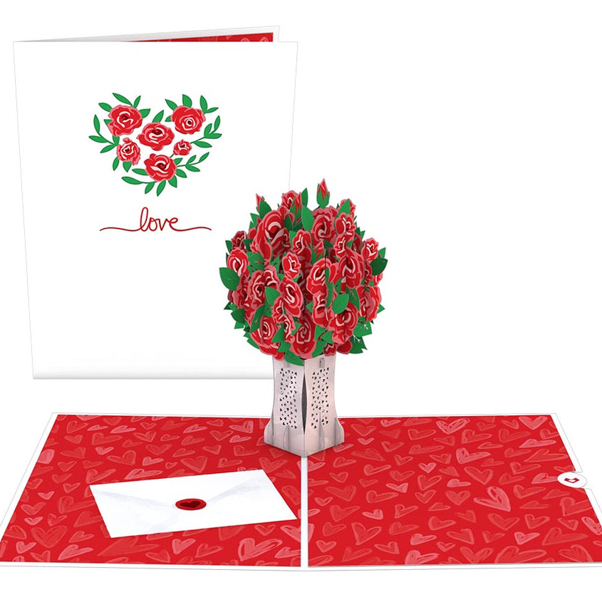 The 3D Love Rose Pop-Up Card features a bouquet of red roses with green leaves that pops up. The card has a white cover with a heart made of roses and the word \“love,\“ and includes a red, heart-patterned interior with an envelope graphic.