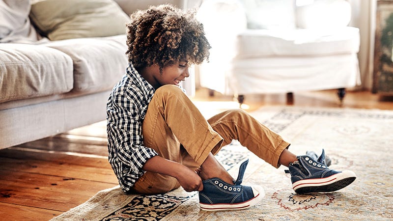 boy putting on shoes