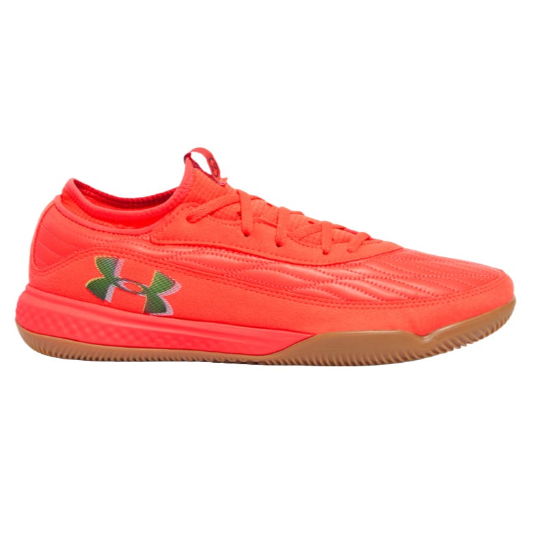 Bright red athletic shoe with a gum sole, featuring the Under Armour logo on the side.