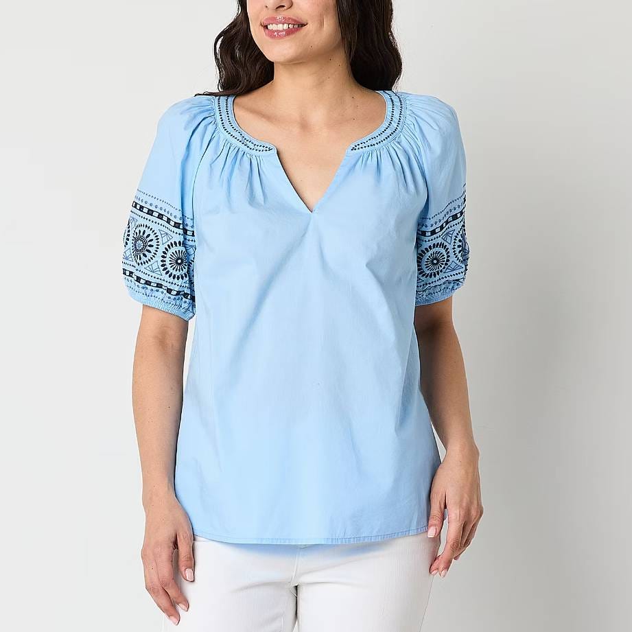 A light blue, V-neck blouse with embroidered short sleeves.