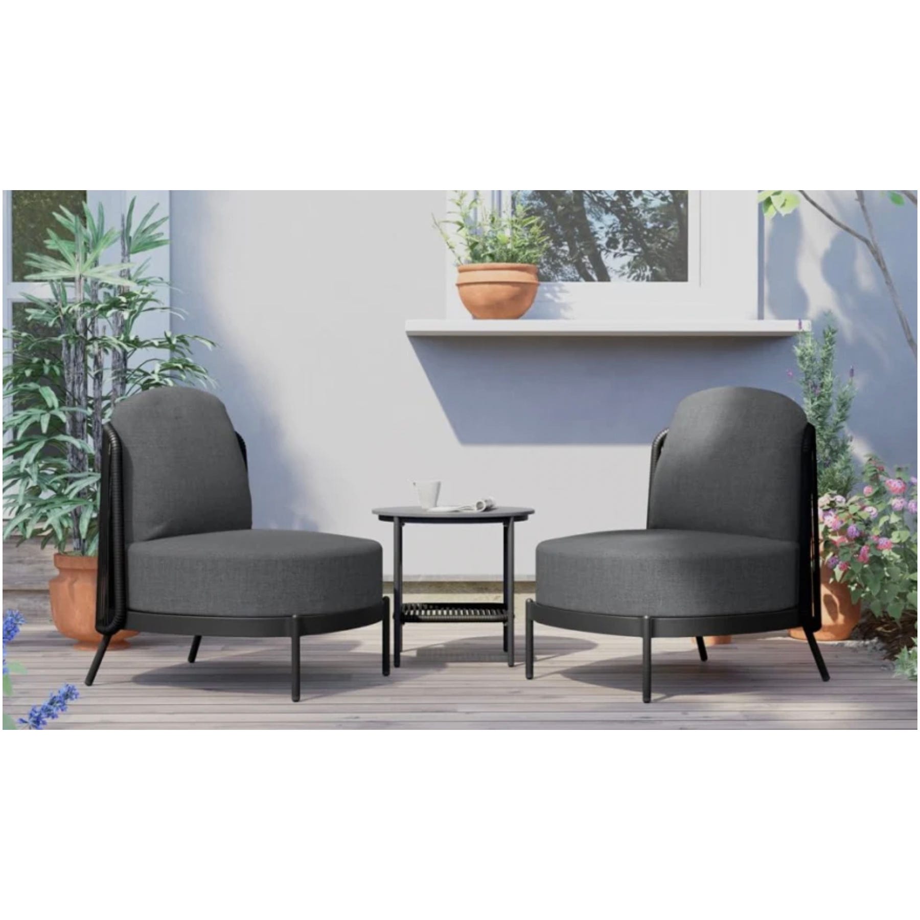 Two gray armchairs with black legs flanking a small round black table, on a wooden deck against a wall with a hanging plant shelf.