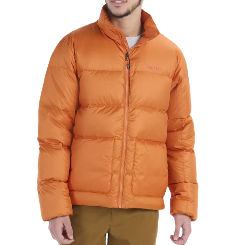 The Marmot Guides Down Jacket is an orange puffer jacket featuring a high collar and zipper closure, designed for warmth and comfort.