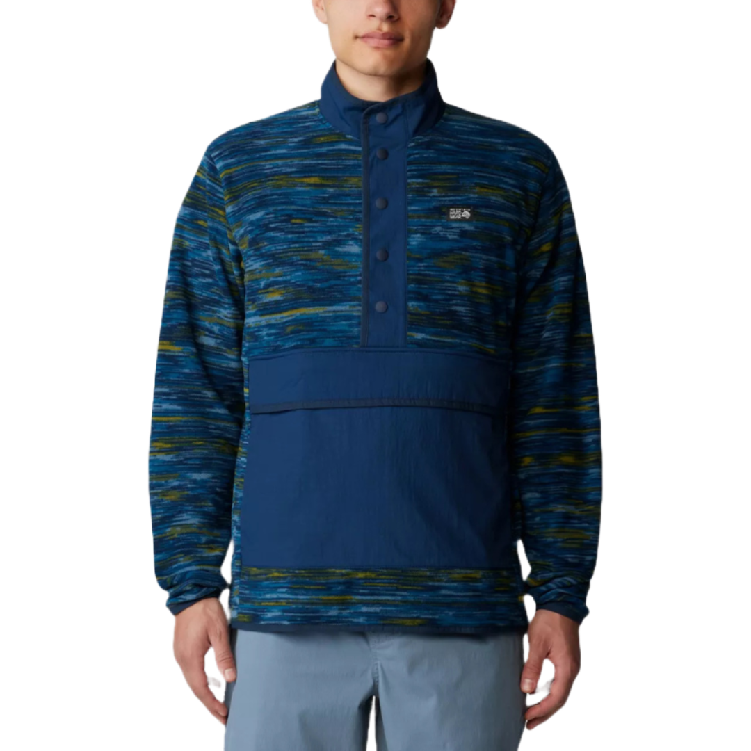 The Microchill Snap Pullover features a blue and green patterned fleece upper with a solid blue snap-up placket and kangaroo pocket, offering a casual, outdoor-ready look. Ideal for layering in cooler weather.