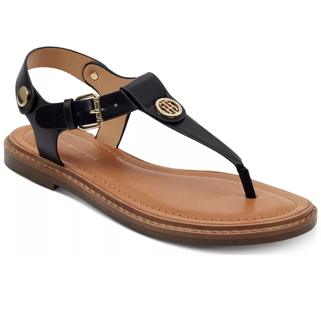 Black thong sandal with a metal logo embellishment and a buckled ankle strap.