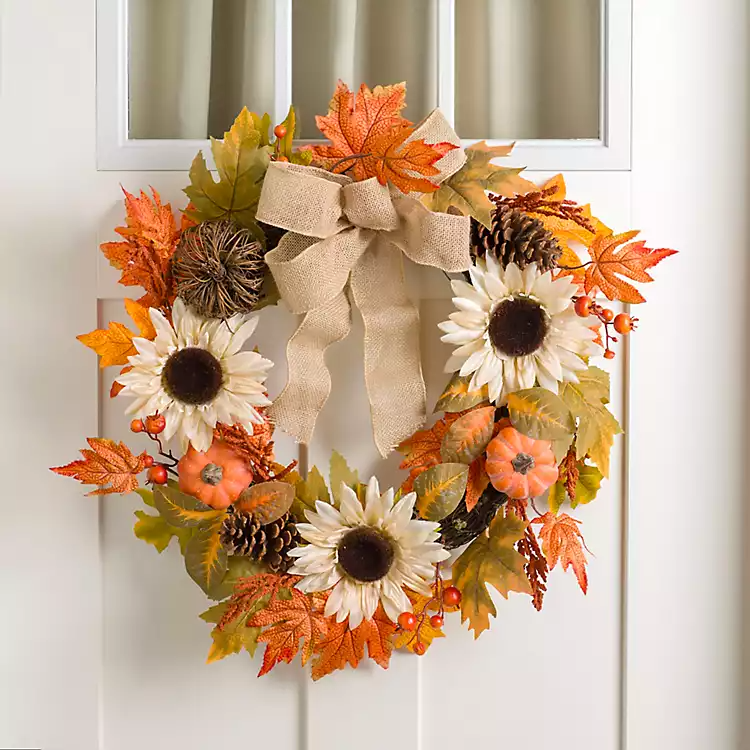Autumn-themed door wreath with sunflowers, orange leaves, pine cones, burlap bow, and pumpkins.