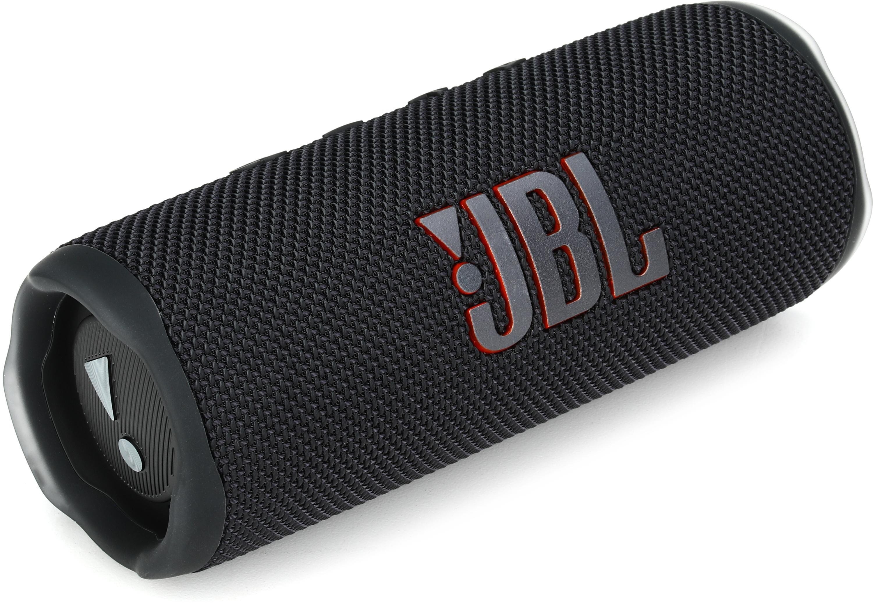 A cylindrical portable JBL Flip 6 speaker with a black textured fabric cover and the JBL logo in red.
