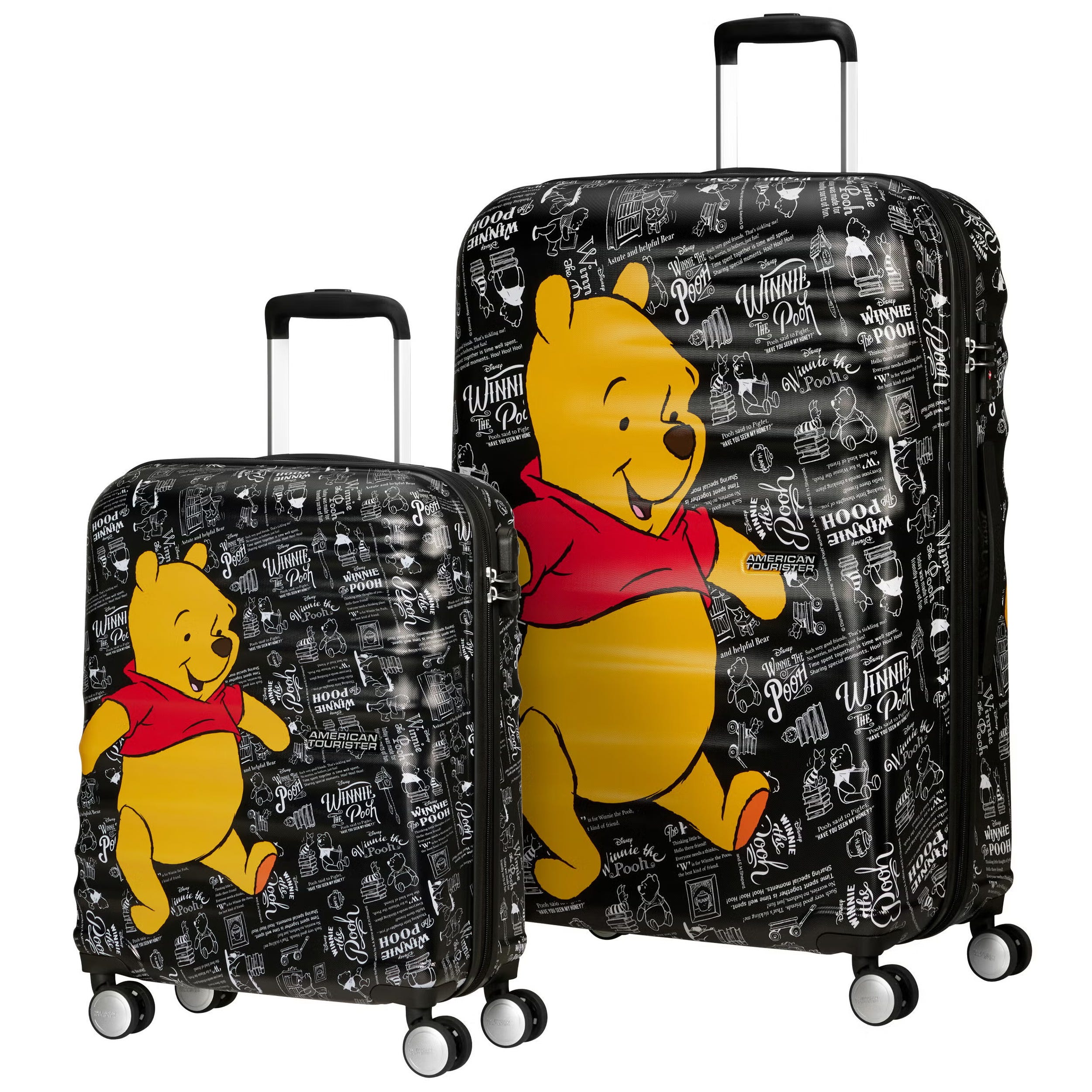 Two suitcases featuring a Winnie the Pooh design with black backgrounds and white doodles. Both suitcases have four spinner wheels and handles, with Pooh depicted in a red shirt.