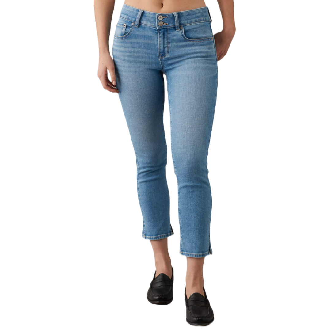 A person is wearing light blue, high-waisted cropped jeans paired with black loafers.
