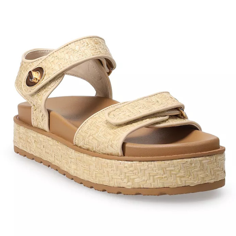 A beige platform sandal with a woven texture, featuring adjustable ankle and toe straps with Velcro closures, and an elevated sole for added height and style.