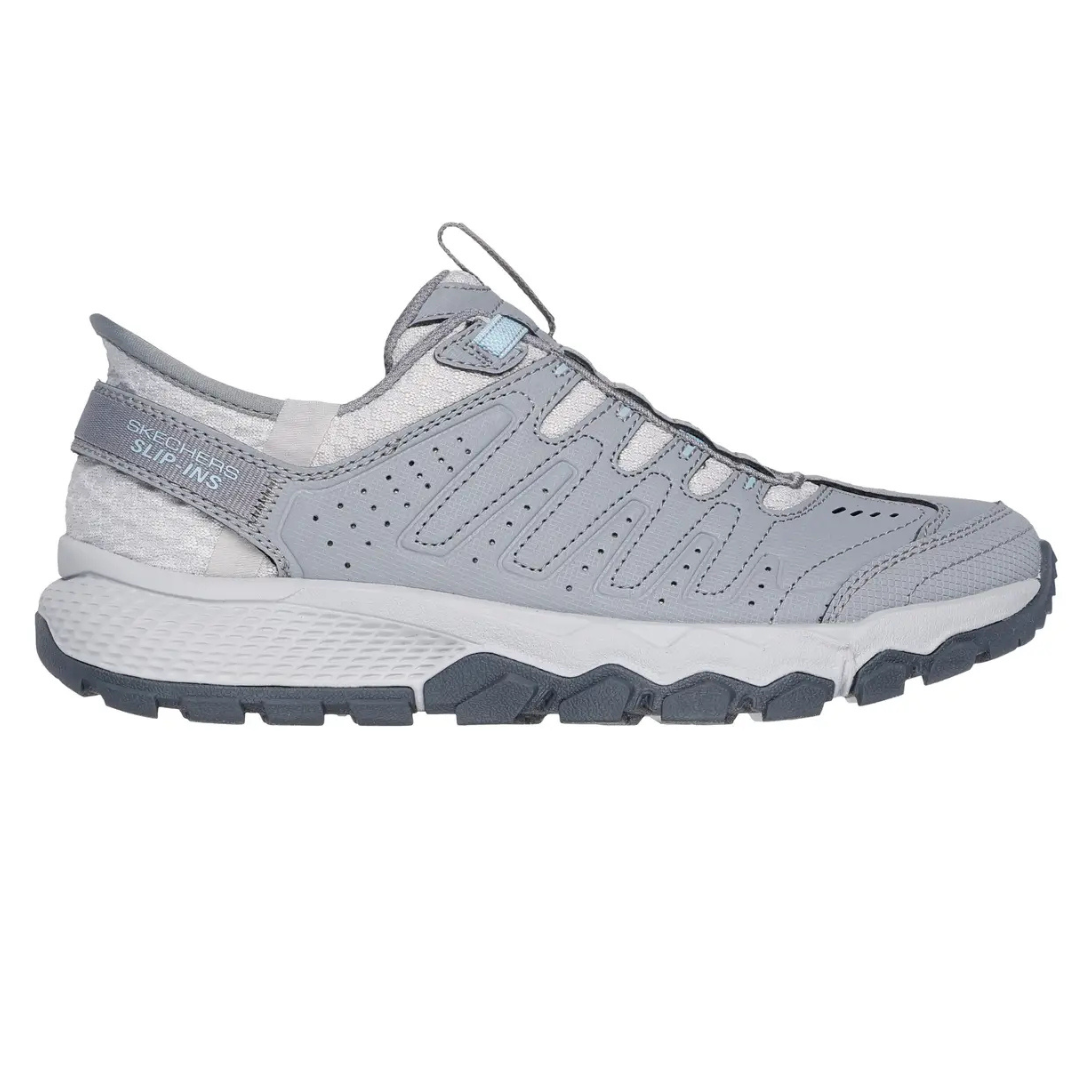 Skechers Women's Dynamite AT Shoes are gray slip-ins featuring a rugged, textured sole for traction and a perforated upper for breathability. They offer convenient on-and-off wear with a pull tab at the tongue.