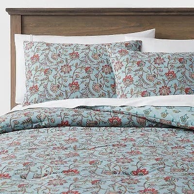 Floral patterned bedding set, including a comforter and pillowcases, with a mix of red and green hues.
