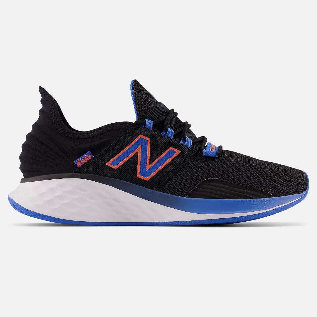 A black New Balance sneaker with white midsole and blue accents.