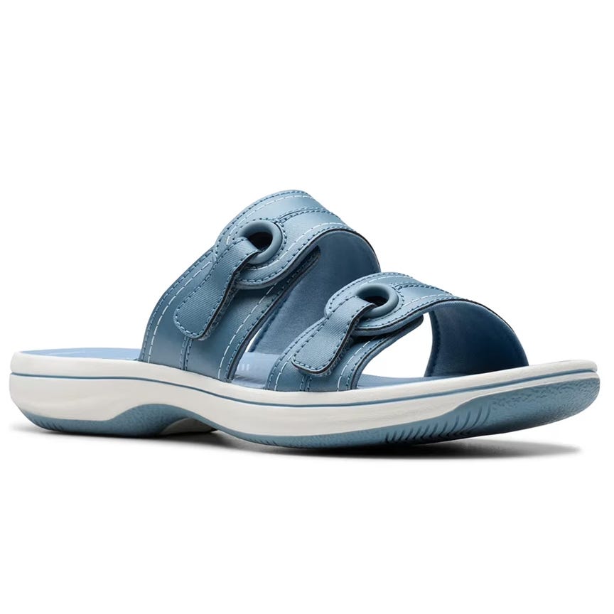 Light blue slide sandal with two adjustable straps and a white sole featuring a textured grip.