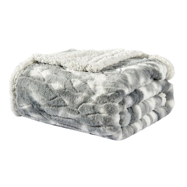 A folded plush blanket with a patterned gray and white top and a solid white soft Sherpa underside.