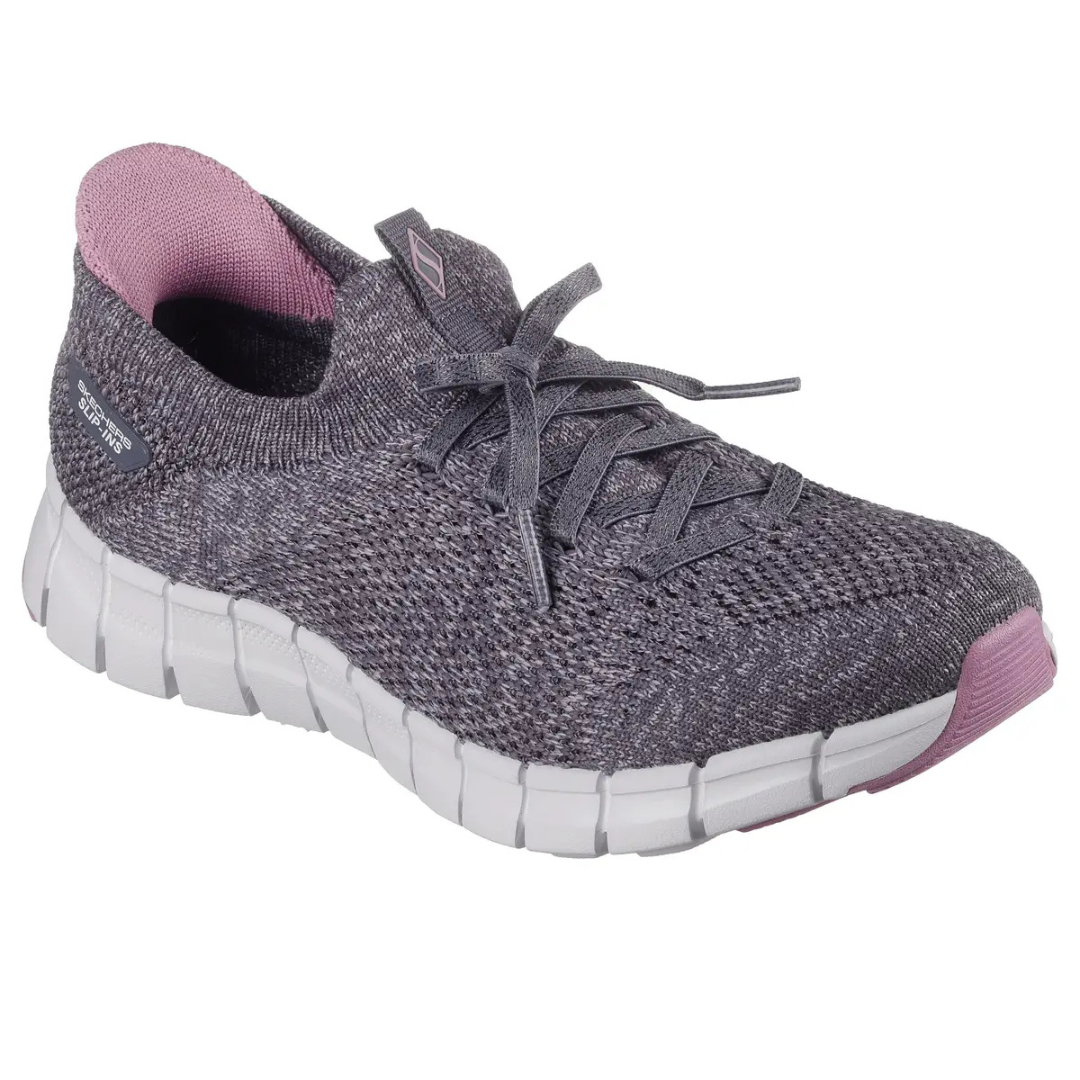 A gray and pink knit sneaker with a flexible white sole and lace-up design. Features a breathable mesh upper and cushioned support.