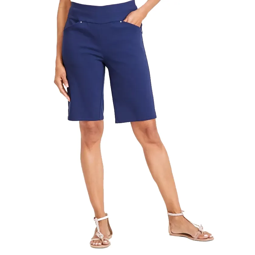 Navy blue Bermuda shorts and beige strappy sandals.
