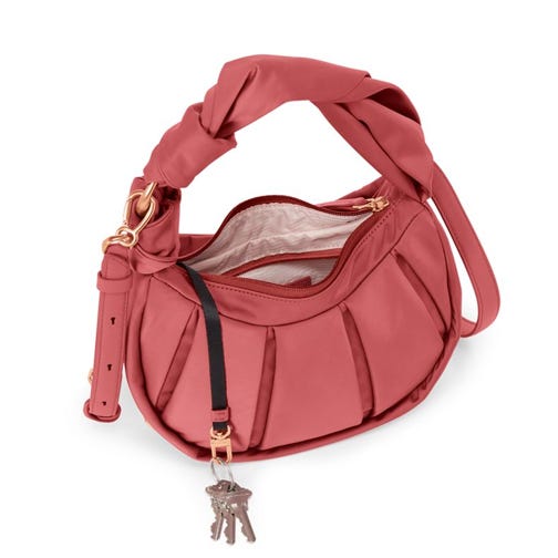 Coral shoulder bag with multiple pockets and a decorative key charm.