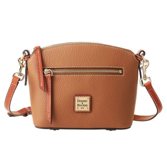 A brown leather crossbody bag with gold-tone hardware features a front zipper pocket and adjustable strap. The brand Dooney & Bourke is displayed on a metal logo plate.