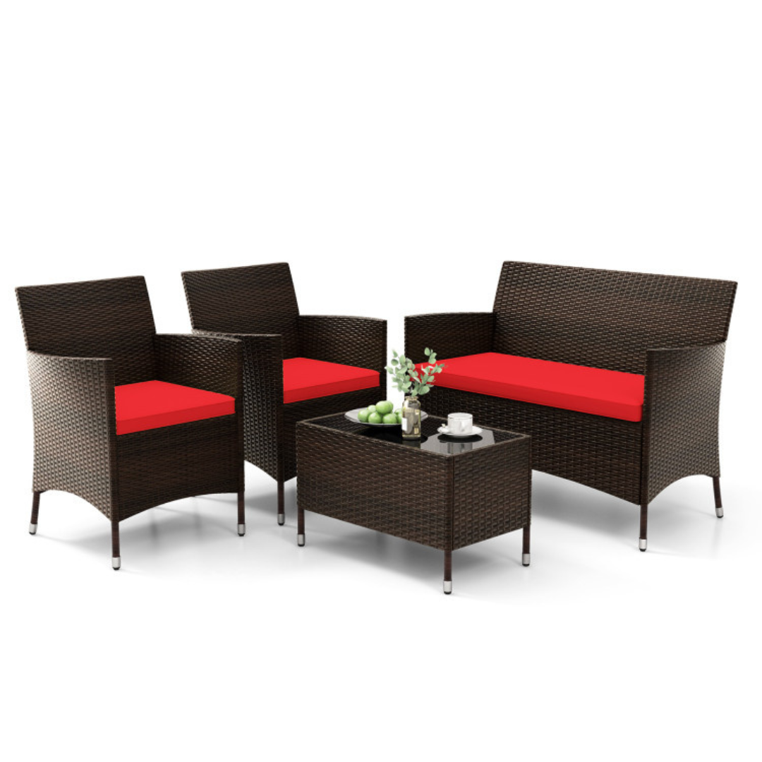4-piece outdoor sofa set includes a small glass-top coffee table, a loveseat, and two armchairs, all made from woven rattan with vibrant red cushions.