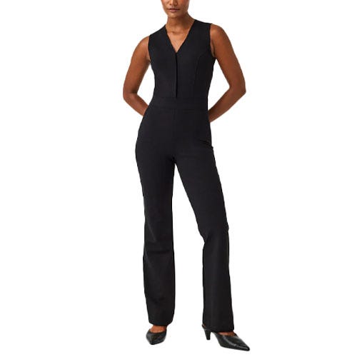 A sleeveless black jumpsuit featuring a V-neck, fitted bodice, and straight-leg pants, paired with pointed black shoes.