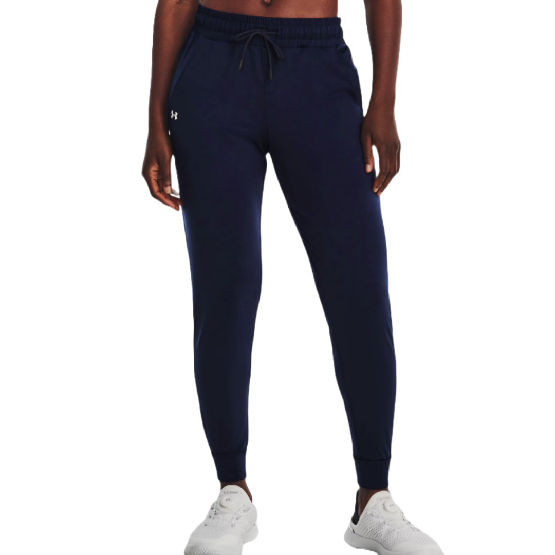 Navy blue joggers with a drawstring waist, elastic cuffs, and a small logo on the left hip. Paired with white athletic shoes.