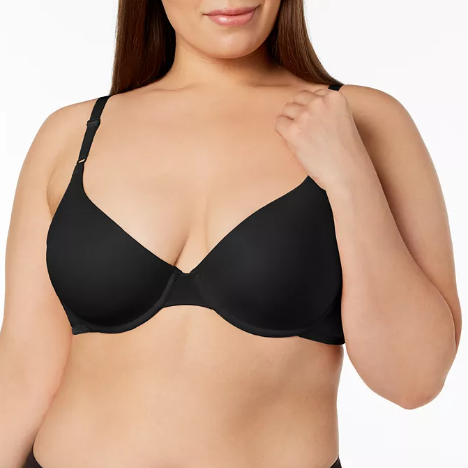 A black bra worn by a woman, featuring adjustable straps and a smooth cup design.