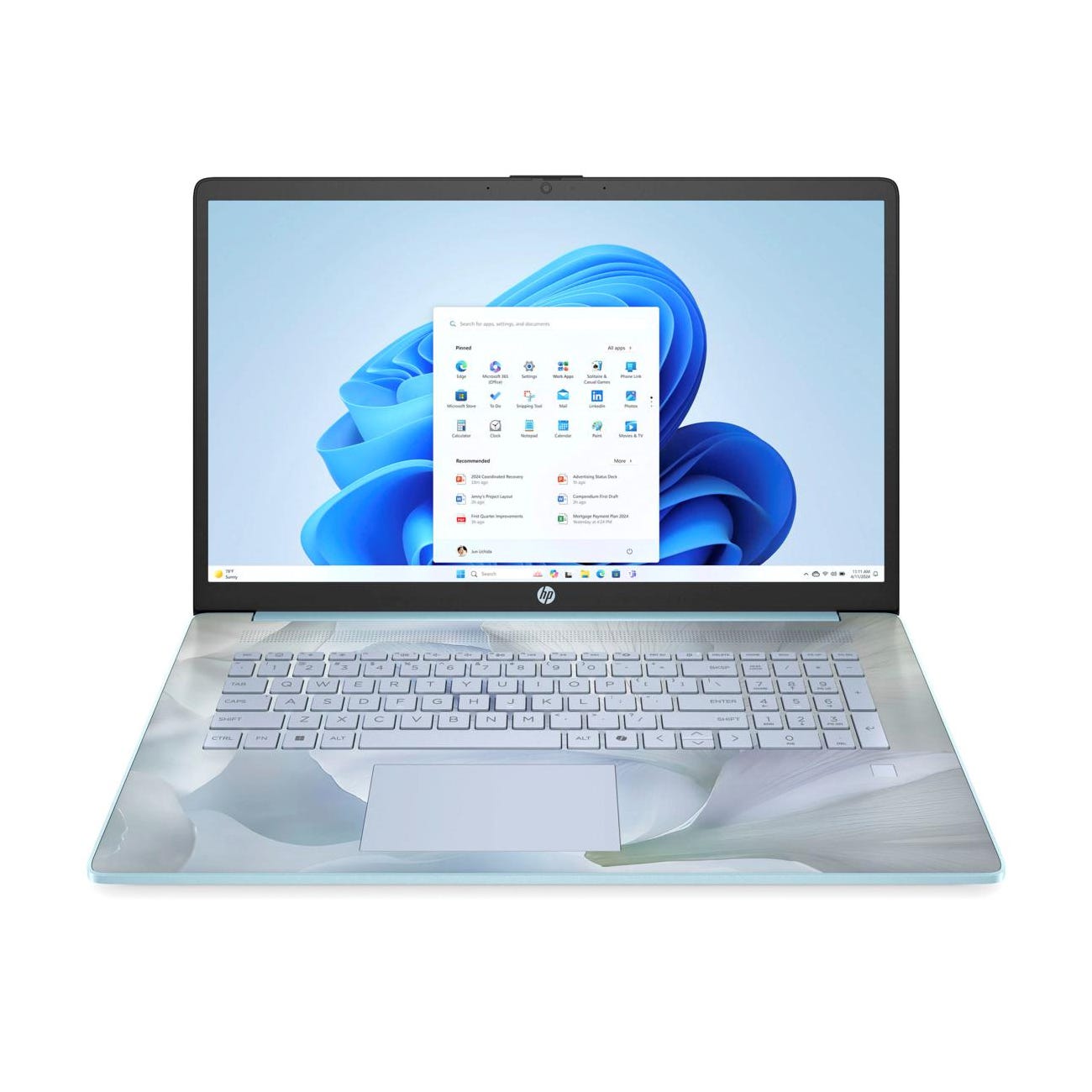 HP laptop with Windows operating system displayed on the screen. The keyboard area features a floral design.