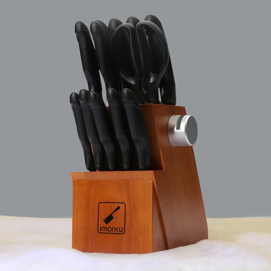 A wooden knife holder with a set of black-handled knives and a sharpening tool.