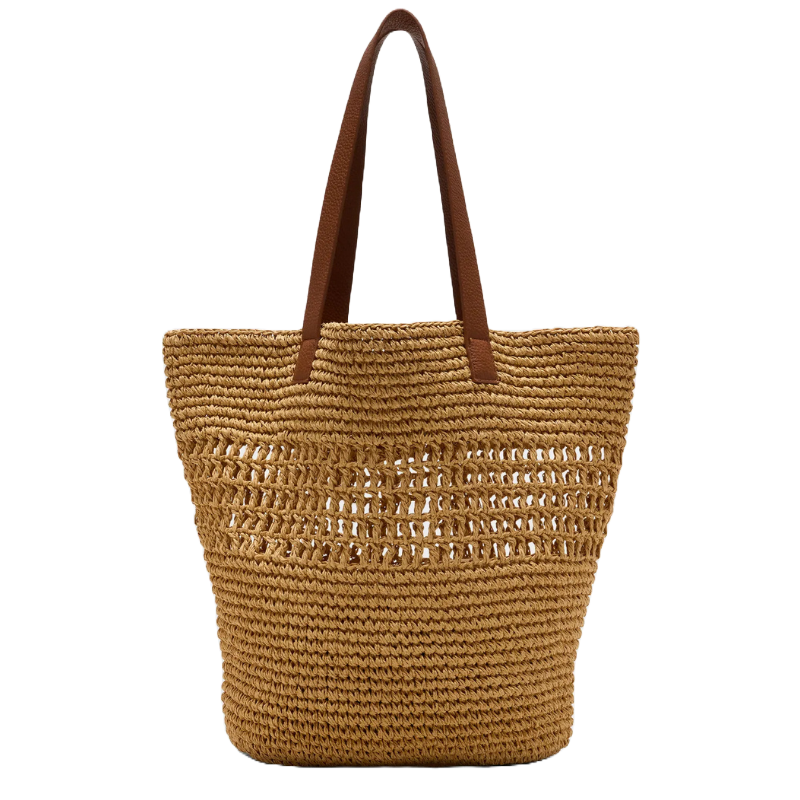 A straw tote with brown handles, featuring a woven design with open patterns in the upper section, ideal for a casual look or beach outing.