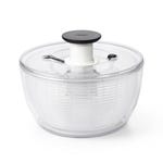 Clear plastic salad spinner with an inner white basket and a black push-down handle on the lid.