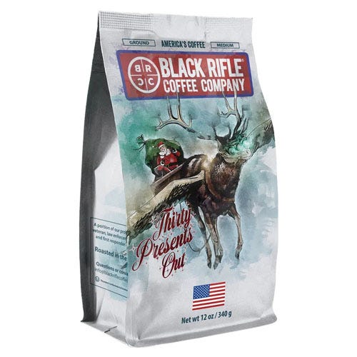 Bag of Black Rifle Coffee Company's \“Thirty Presents Out\“ roast, featuring a holiday-themed design with illustrations of Santa and a reindeer. It's ground, medium roast coffee, 12 oz (340 g), with an American flag motif.