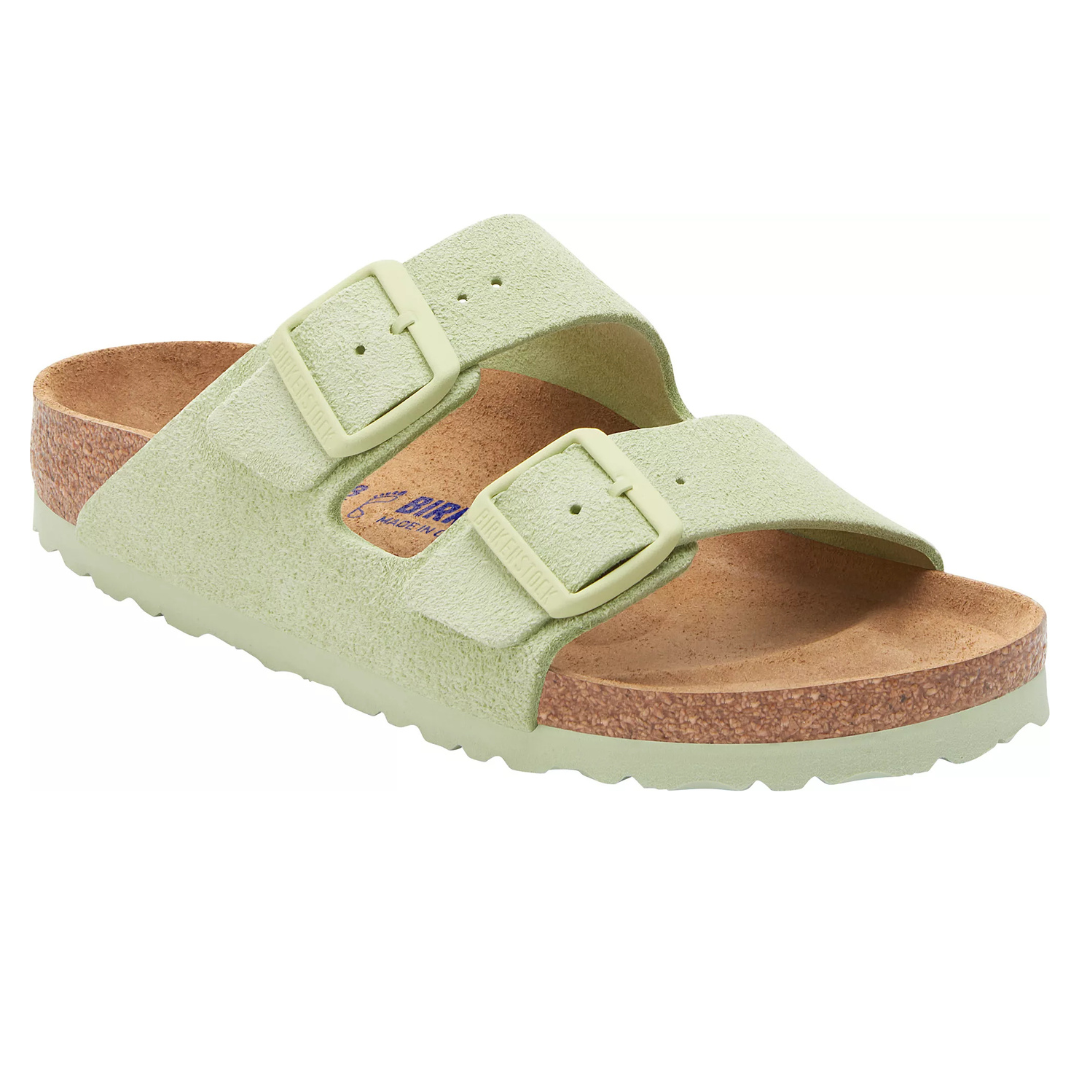 A light green sandal with two adjustable straps and a cork footbed, likely designed for comfort and support.