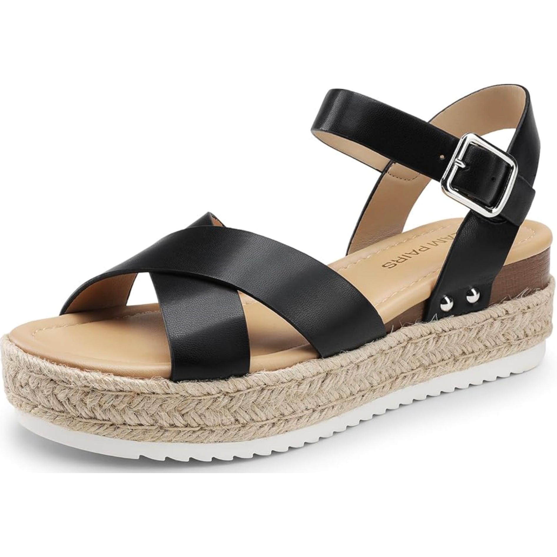 Black sandal with crossover straps, adjustable ankle buckle, and a platform sole with a braided jute trim.
