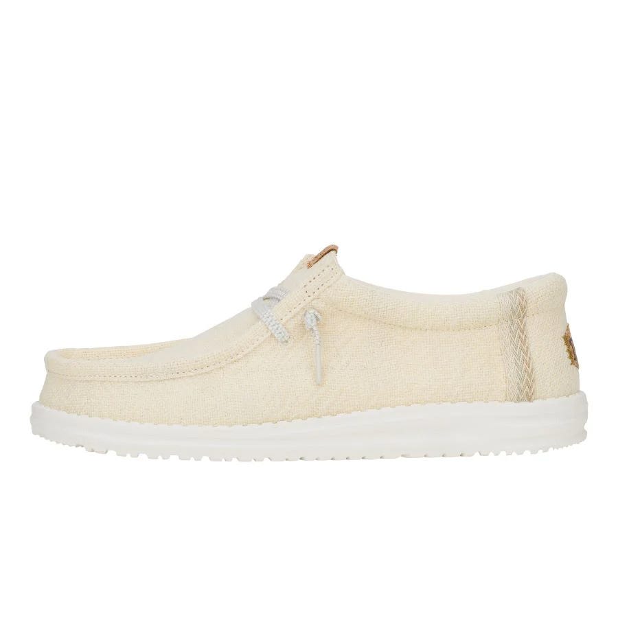 Hey Dude Wally Jute Shoes are lightweight, casual slip-ons with a natural jute canvas upper, cushioned white sole, and elastic laces for easy wear.