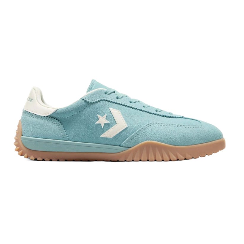 A light blue low-top sneaker with a white star and chevron logo, featuring a textured gum sole and suede material.