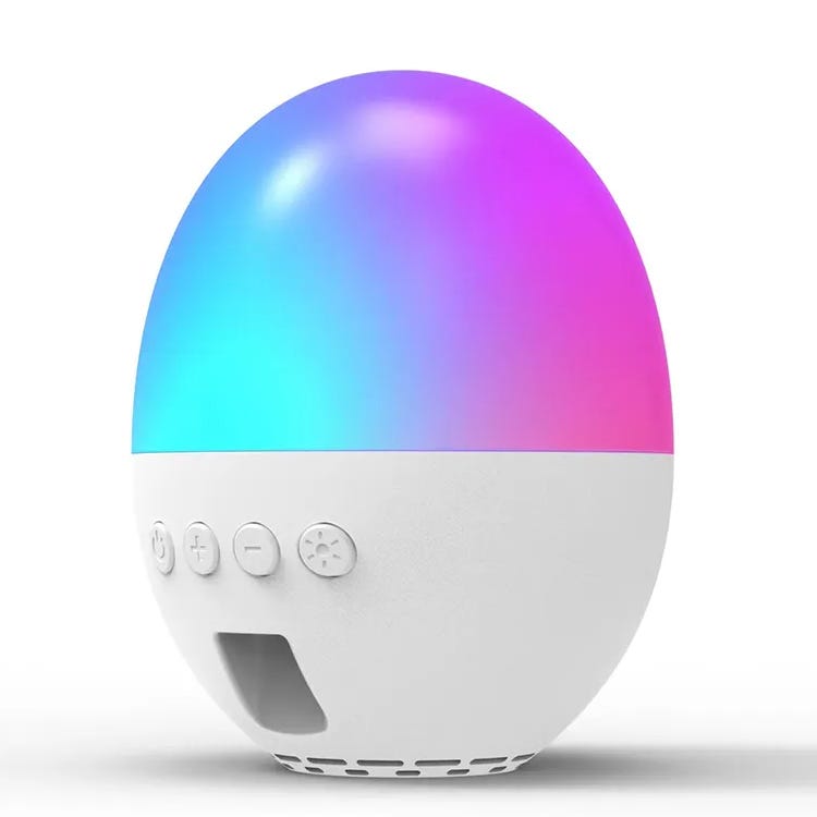 A spherical white noise machine and speaker with a gradient LED light display, featuring buttons for power, volume control, and function settings, housed in a white, egg-shaped body.